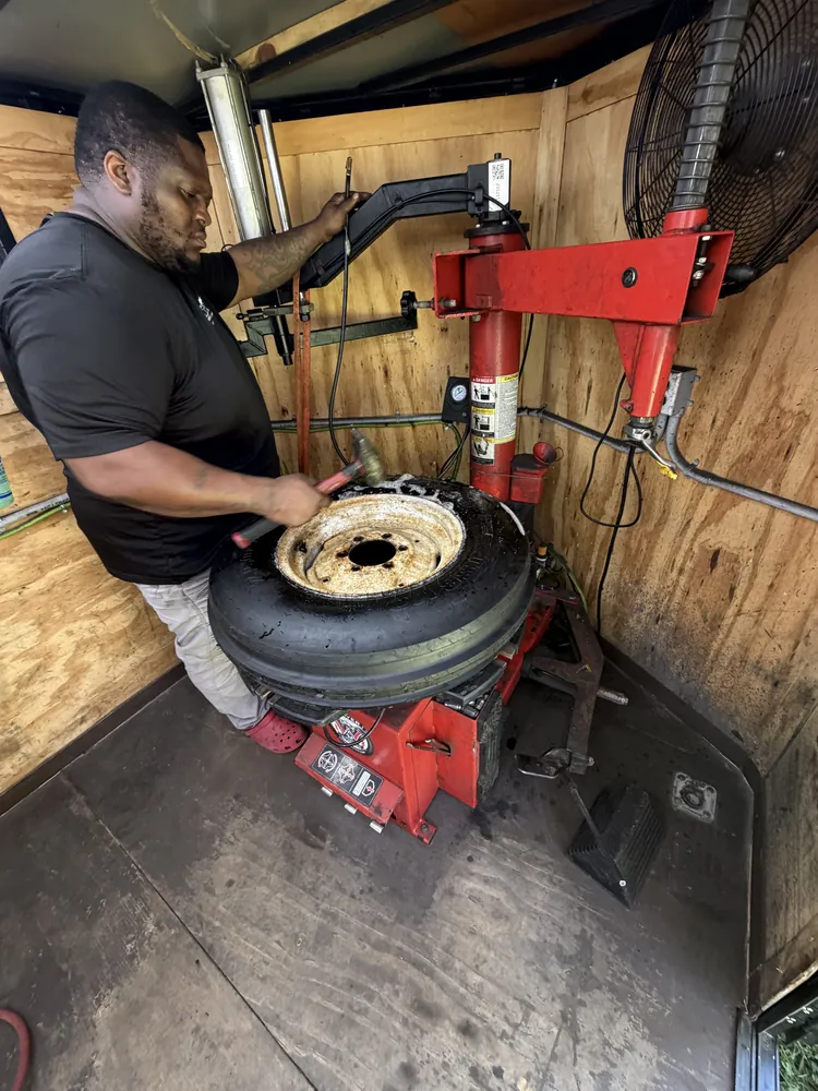 Joe Taylor repairing a mower tire on the tire machine in Ocala, Florida