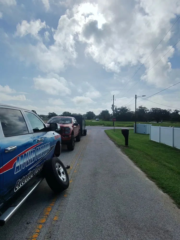 Work truck with its wheel off during roadside tire service on a Marion County road